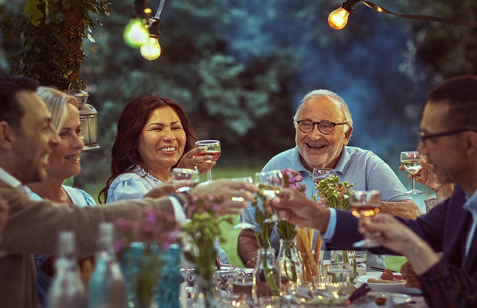 image shows happy people at dinner
