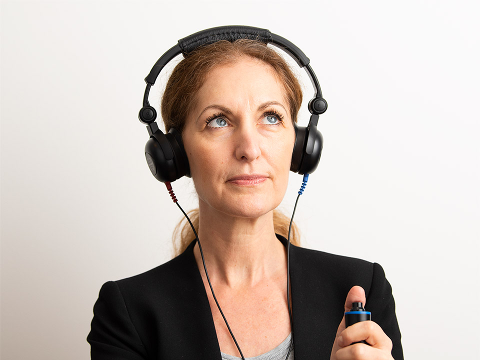 Image shows woman during hearing test