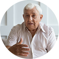 Image shows elderly man talking