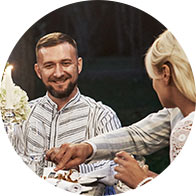 Image shows smiling man at a dinner