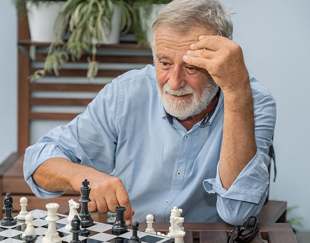 image shows man playing chess